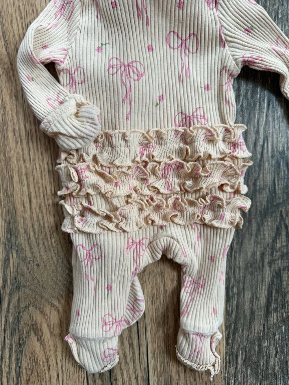 Neutral Cream Ribbed One-Piece with Pink Bow Print and Ruffle Trim and Headband